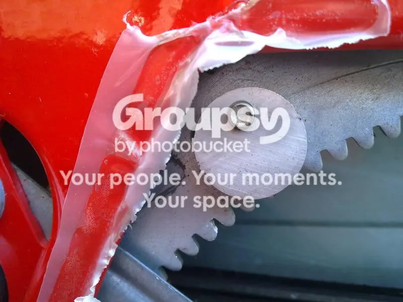 The adjustment disc held by a single bolt, with the door shell painted red