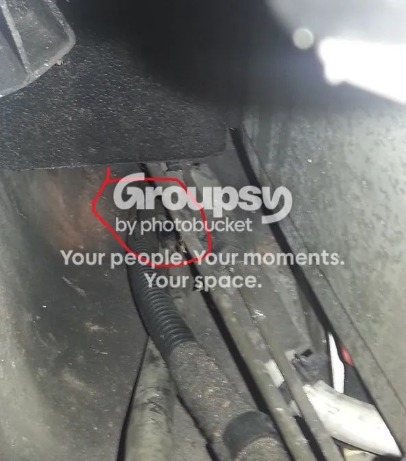 Looking along the nearside sill floor with a red circle round a hose clip