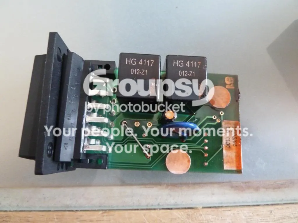 The CDL module with its case removed, showing a green circuit board with two black HG 4117 relays and a connector block