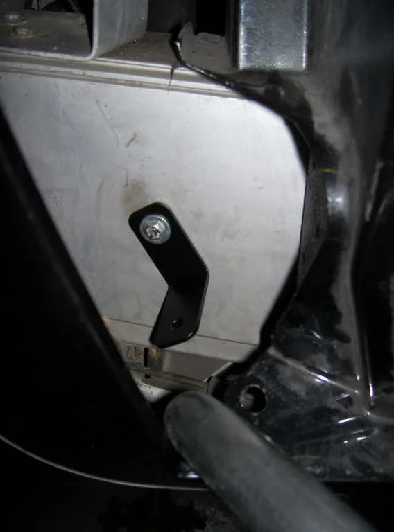 A black steel bracket fixed to the lower edge of a silver panel