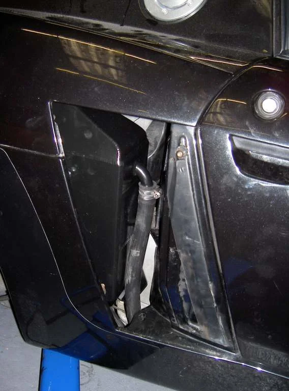 The side of a black car with the charge cooler visible behind the side intake