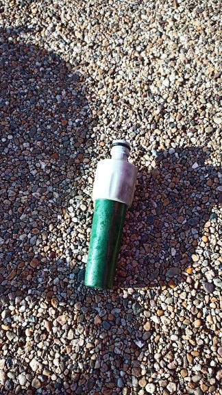 A green hose attachment used as a blanking plug