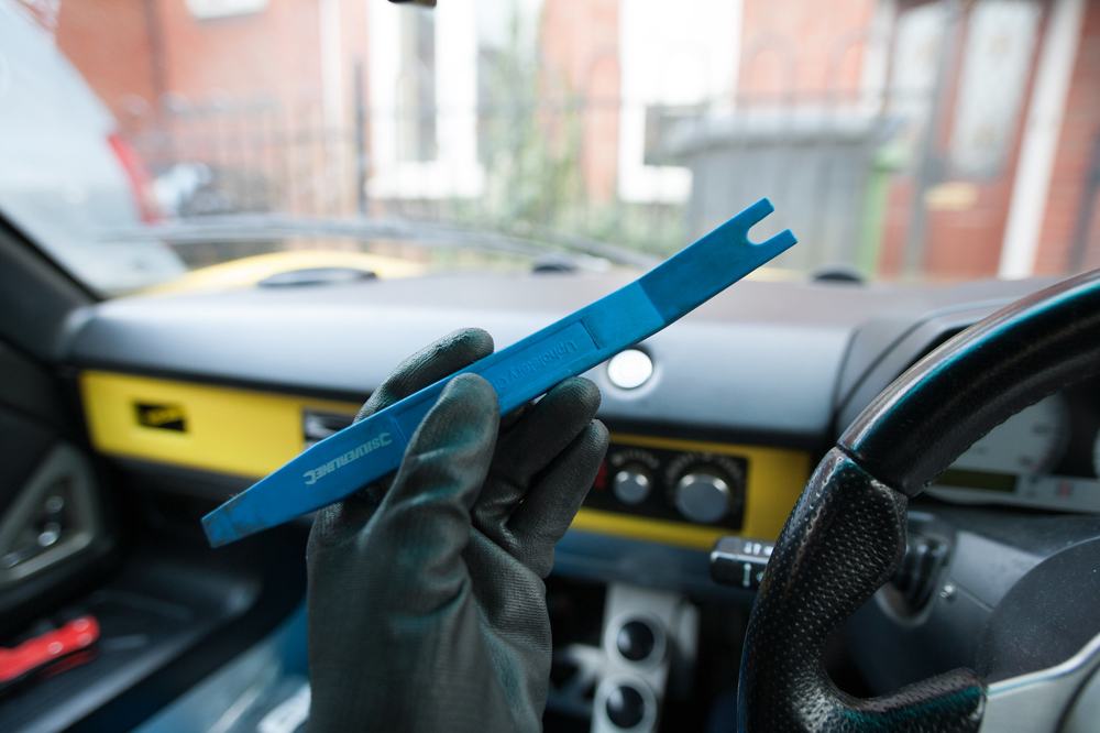 A blue plastic trim removal tool