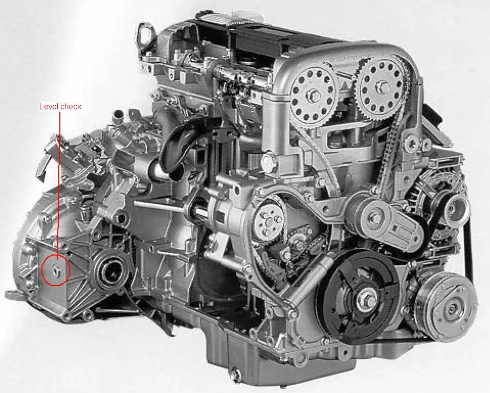 A photograph of an engine and gearbox with a red label and line marking the gearbox level check plug