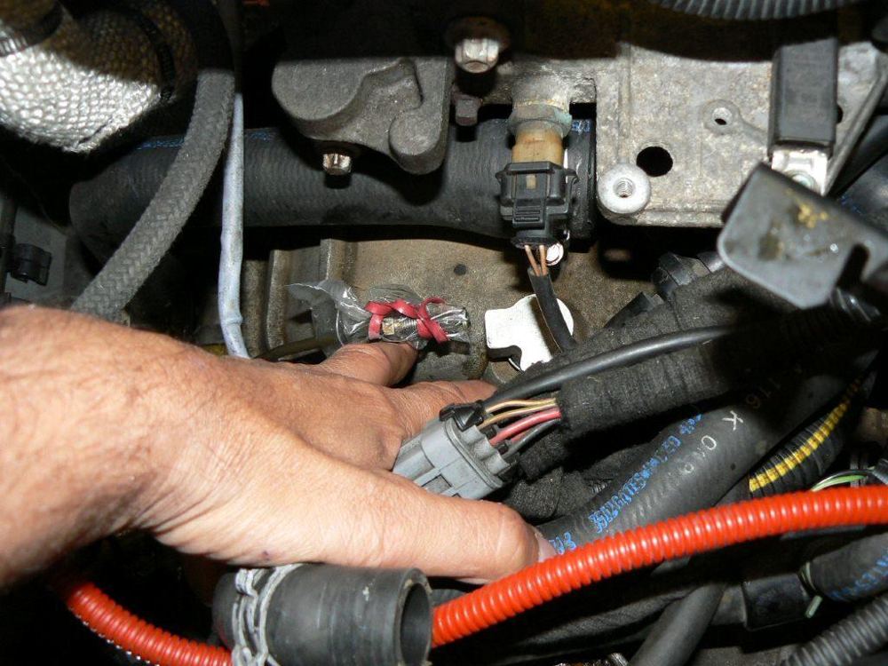 A hand on the wiring plug on the gearbox