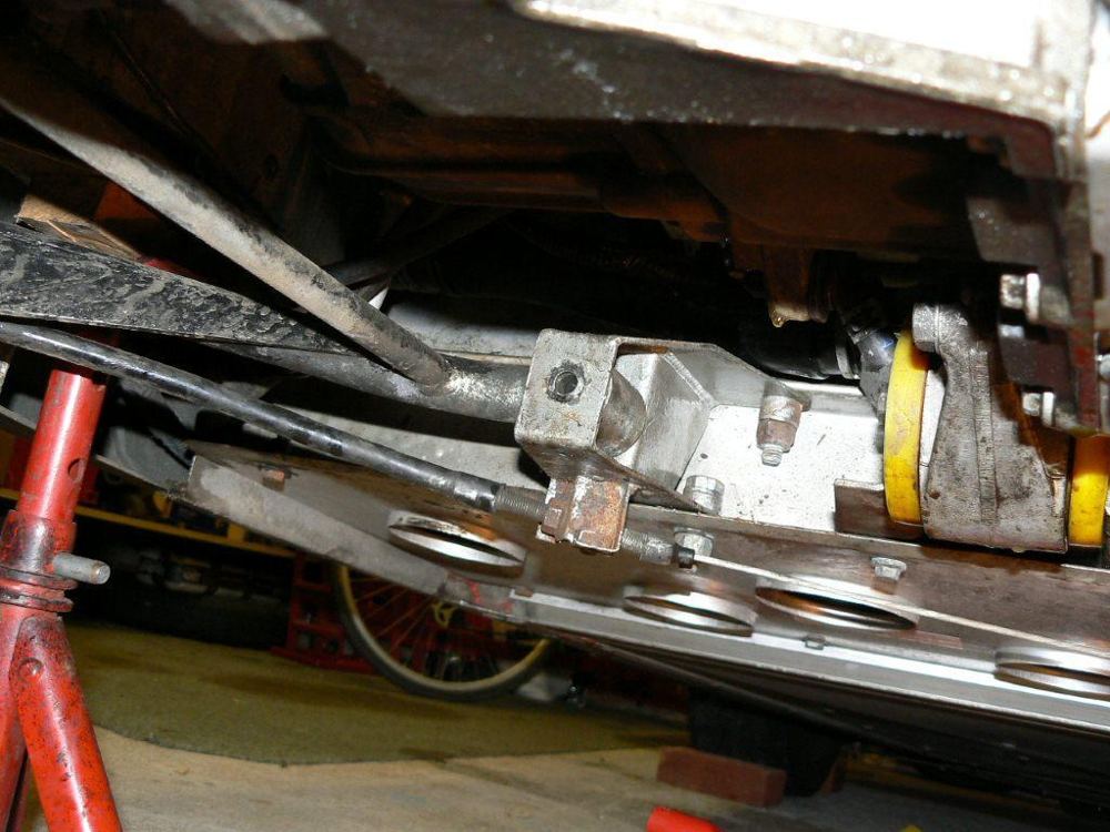 The wishbone and gearbox seen from underneath, with an axle stand