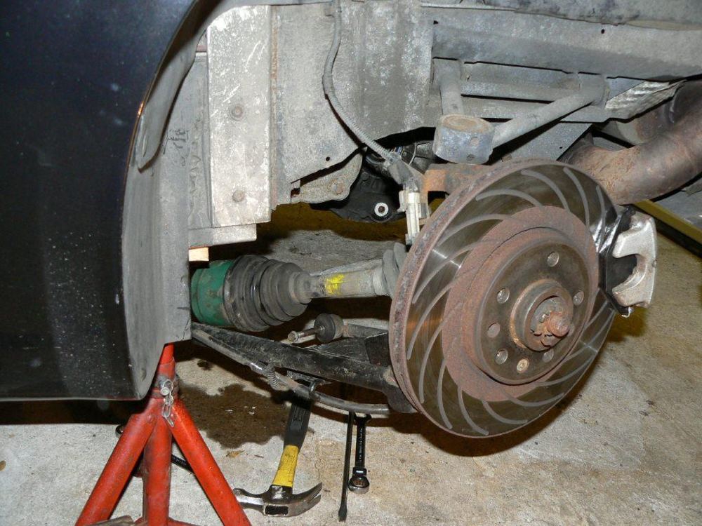 The driveshaft pulled partly out of the gearbox, with the green shaft end visible