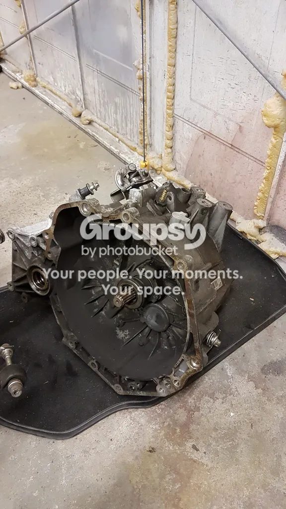 The F23 gearbox on its side on the floor with the bell housing facing up
