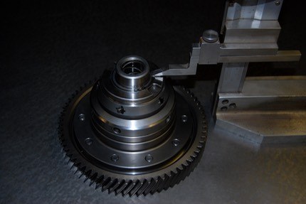 The limited-slip diff with the crown wheel fitted standing on a surface plate beside the height gauge
