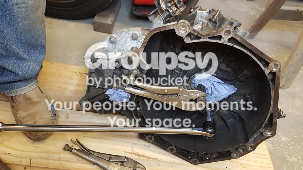 Mole grips clamped on the input shaft with a breaker bar on a socket in the bell housing