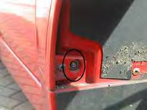 The screw inside the wheel arch, circled