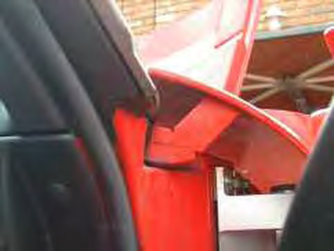 The red bracket above the door hinge