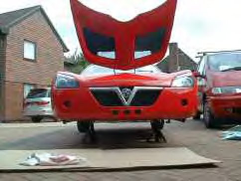 Front of the car on axle stands with the bonnet open