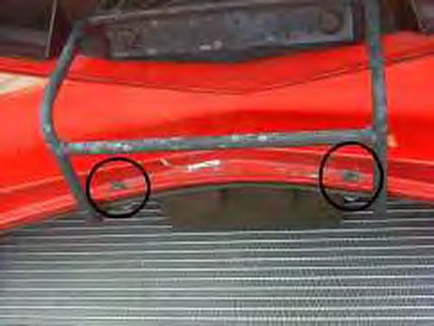 Two circled screws on the radiator surround