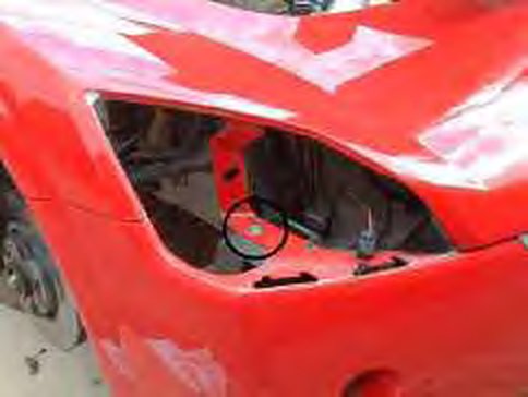 The 13 mm bolt beneath the headlamp aperture