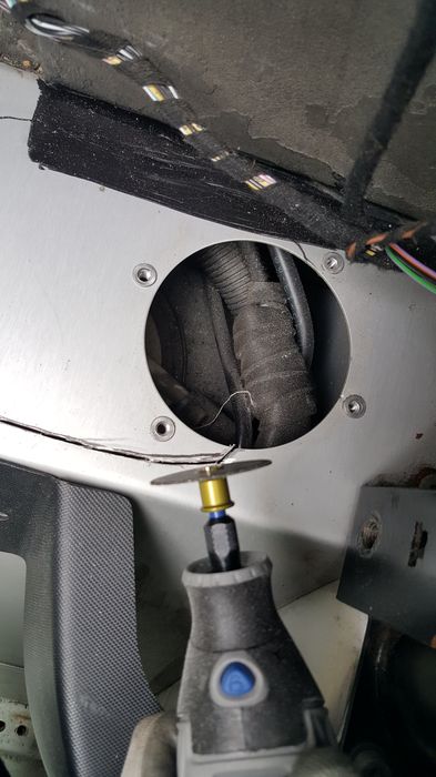 Dremel cutting with the loom visible through the hole