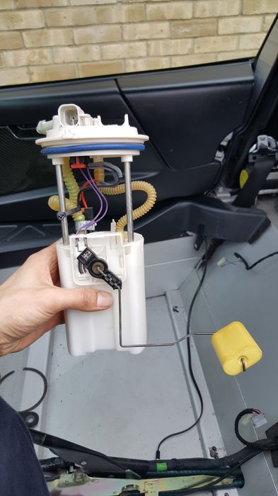 The pump housing held up outside the car