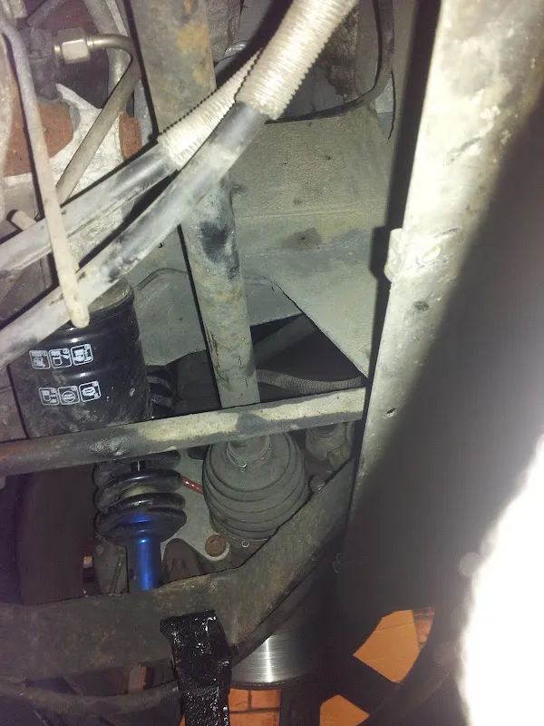 A view up into the rear wheel arch area with cables running along the underside
