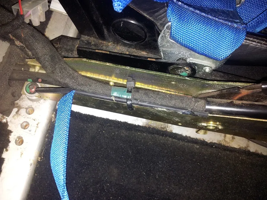 The wiring harness running along the remote gear assembly with cable ties