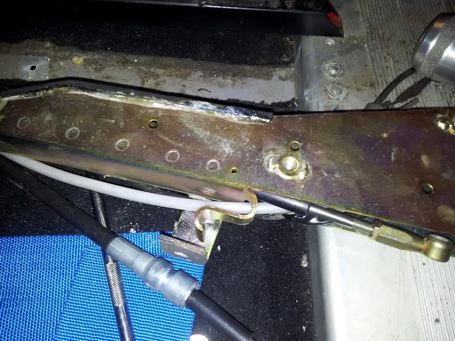 The S-shaped bracket beside the cable ends in the remote assembly