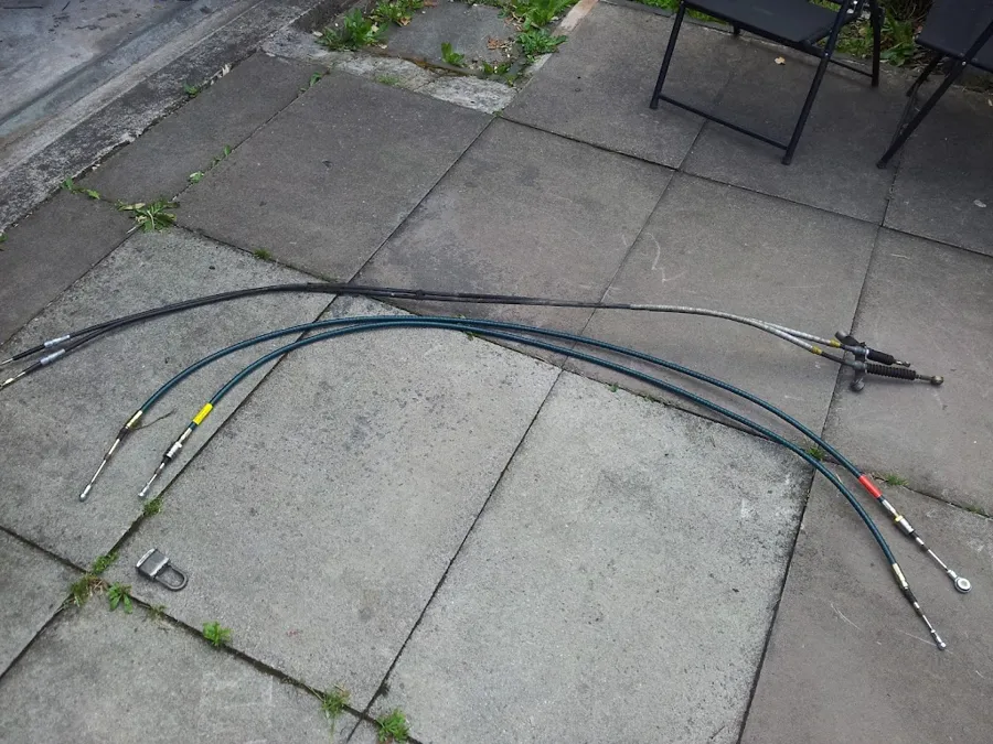 The old and new gear cables laid out on paving