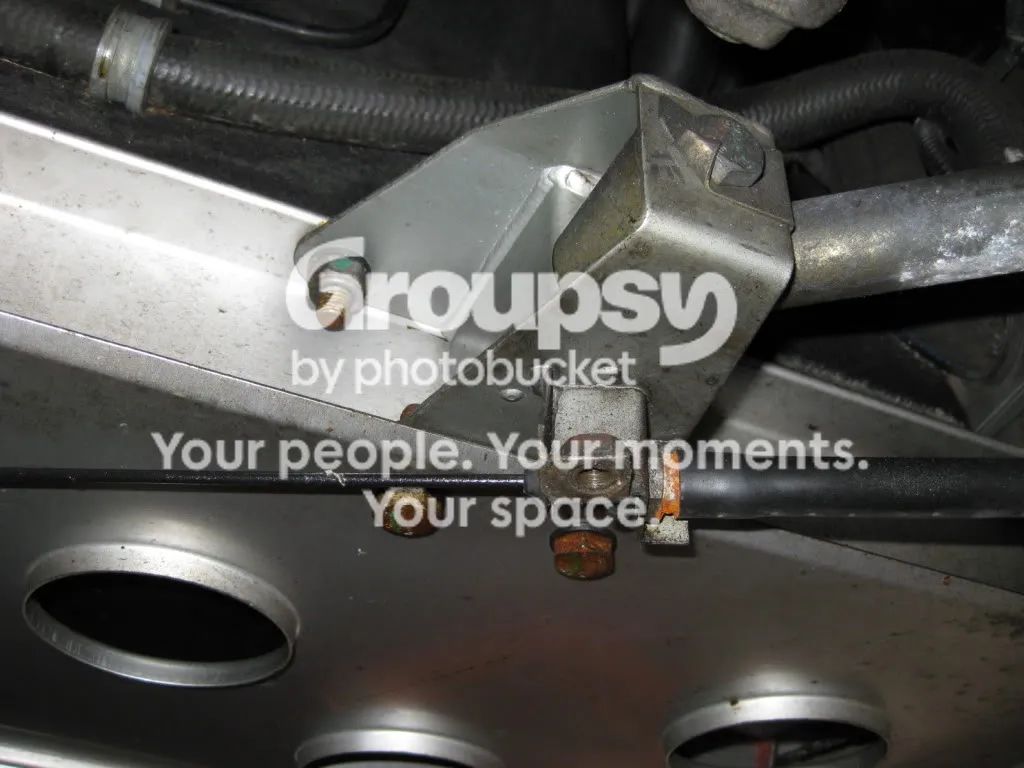 The crescent-shaped bracket on the rear of the car with its adjusting bolts and washers