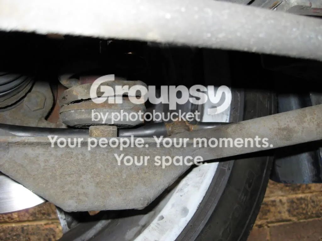 A P-clip and cable along the rear wishbone near the hub