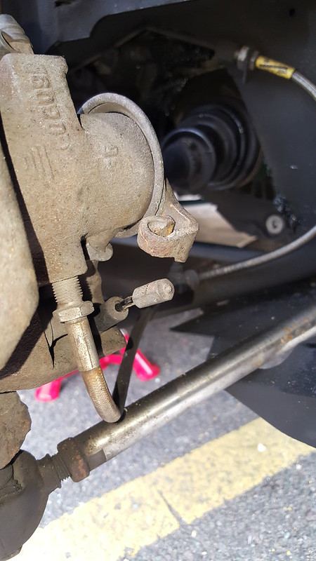 The handbrake cable at the caliper