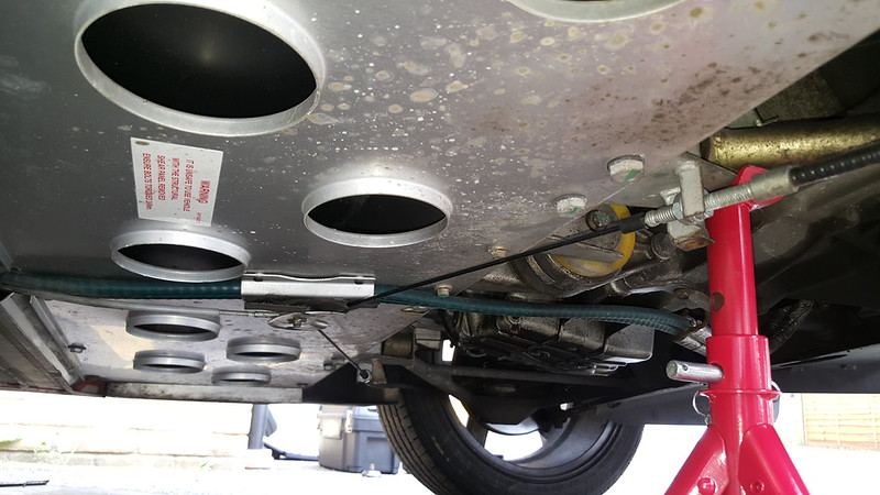 The 17 mm nuts on the handbrake cable bracket near the axle stand