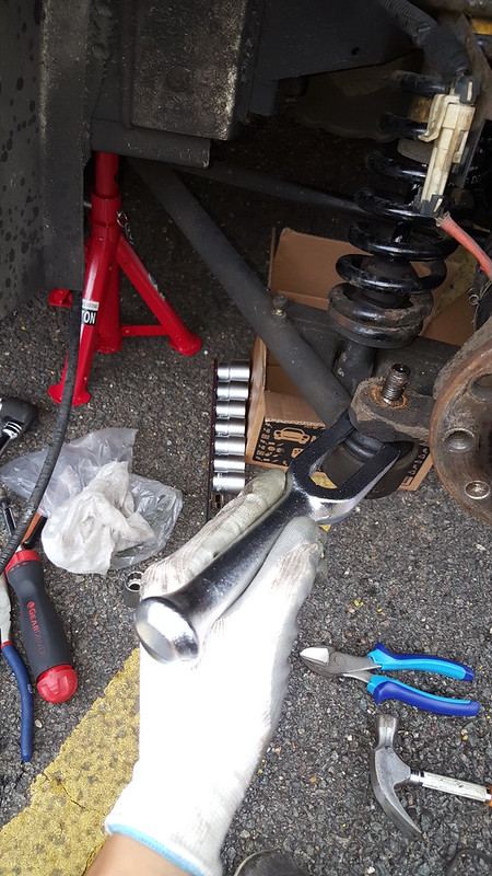 A ball joint separator being hit with a hammer