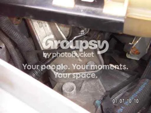 The bracket that bolts to the gearbox end of the engine