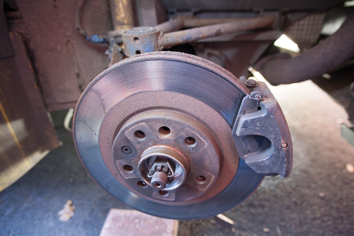 The rear brake disc, caliper and hub with the wheel removed