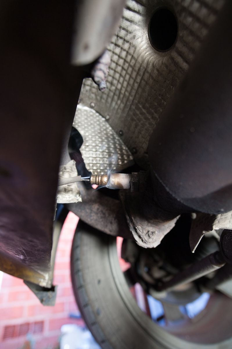 A closer view of the sensor screwed into the exhaust beside the heat shield
