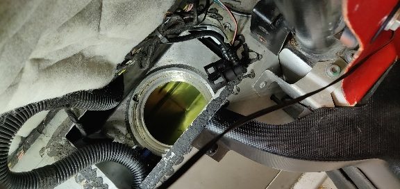 Inspection hatch open showing the pump flange and fuel