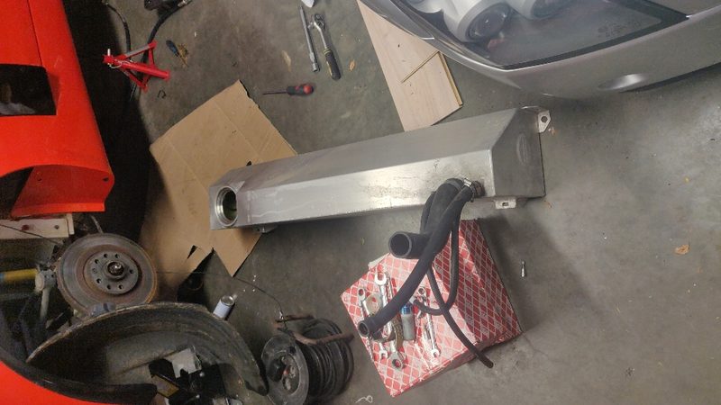 The new alloy tank on the floor with hoses and parts