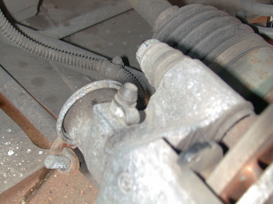 The rear caliper with the 17 mm bolt at the top and the pad pin below