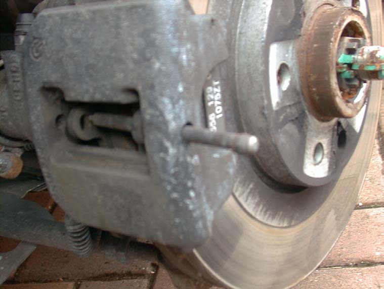 The rear caliper with a pin partly driven out of it