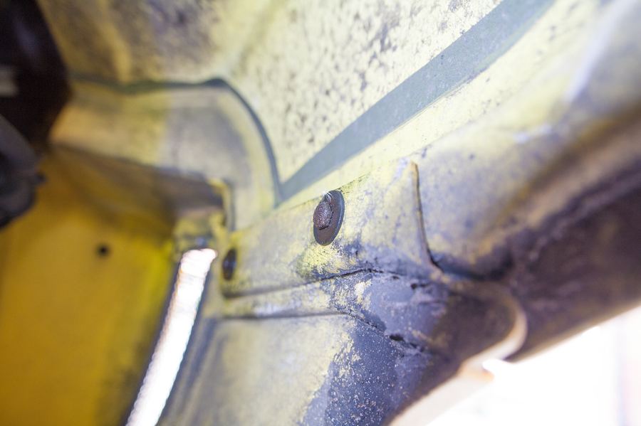 The two 10 mm bolts forward of the wheel, behind the side vent