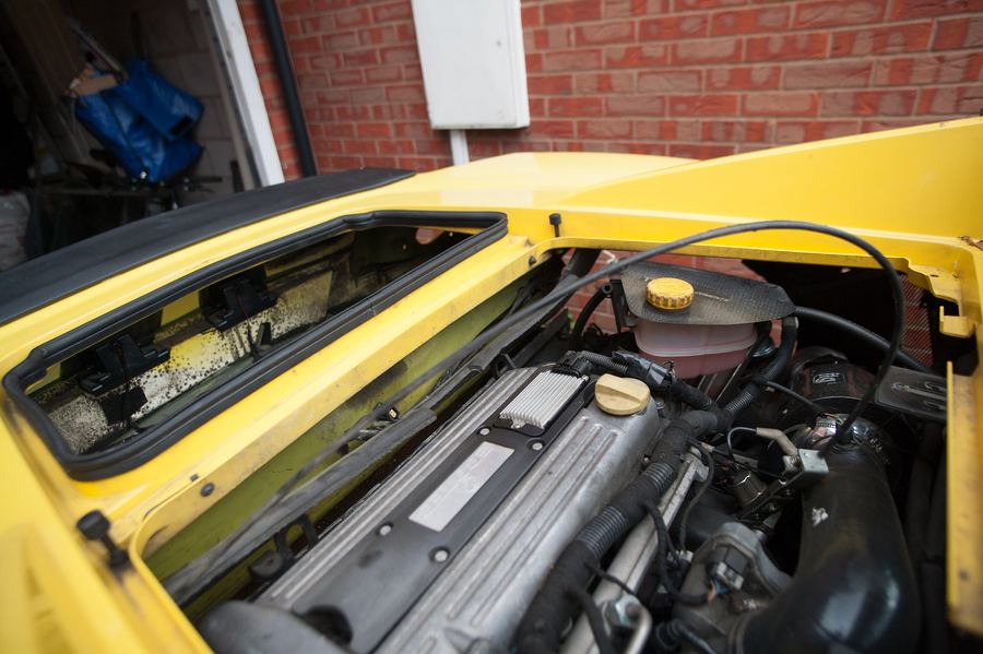 The engine bay with the boot lid removed and lock stowed on the engine