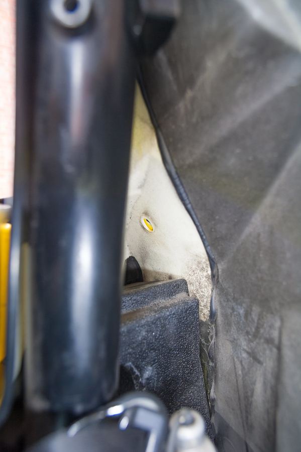 The cavity behind the door pins with the 13 mm bolt