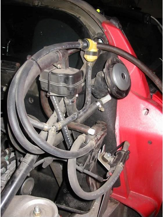 Fuel vapour hoses and canisters behind the clam
