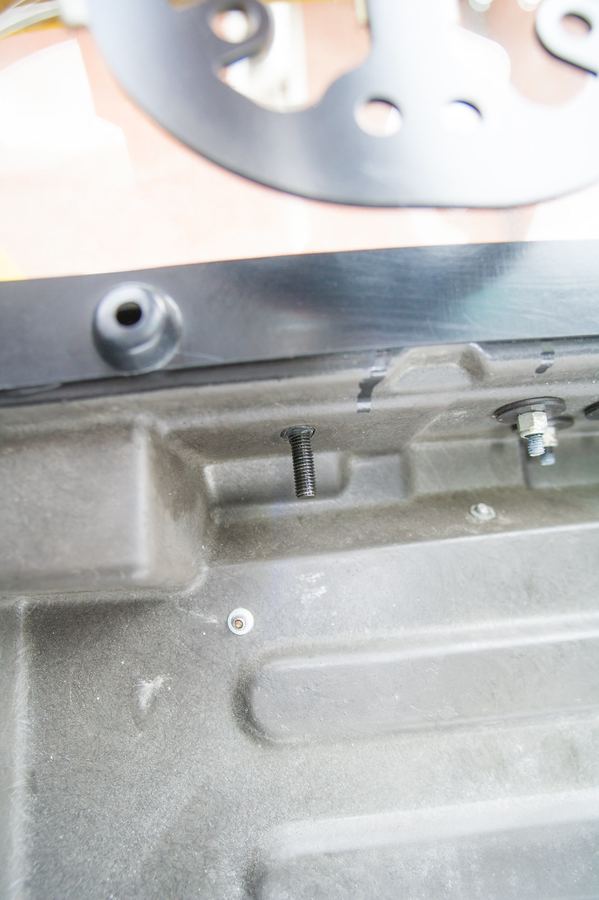 The black stud and 13 mm nyloc nut under the headrest