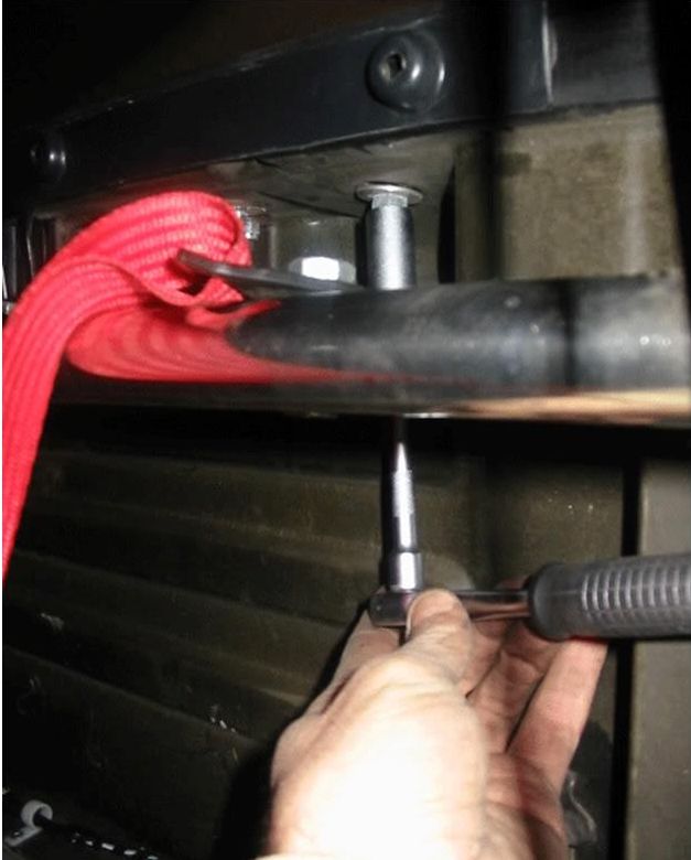 A bolt under the rear window being undone