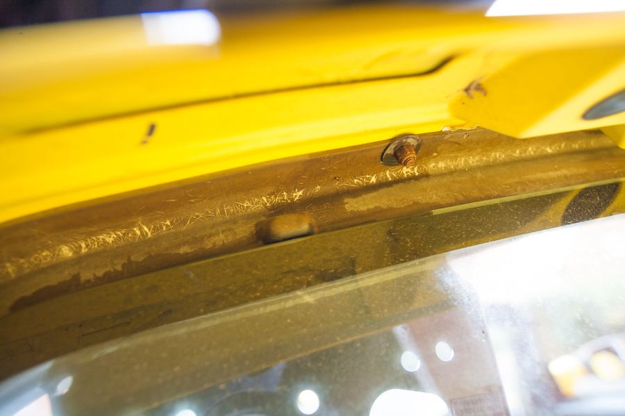 The central 10 mm bolt on the roll bar cover