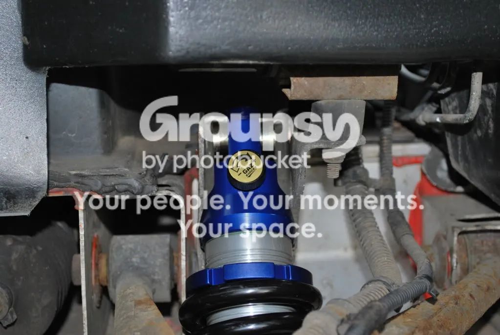 The new blue shock in the front top bracket, with the bracket bent slightly to fit