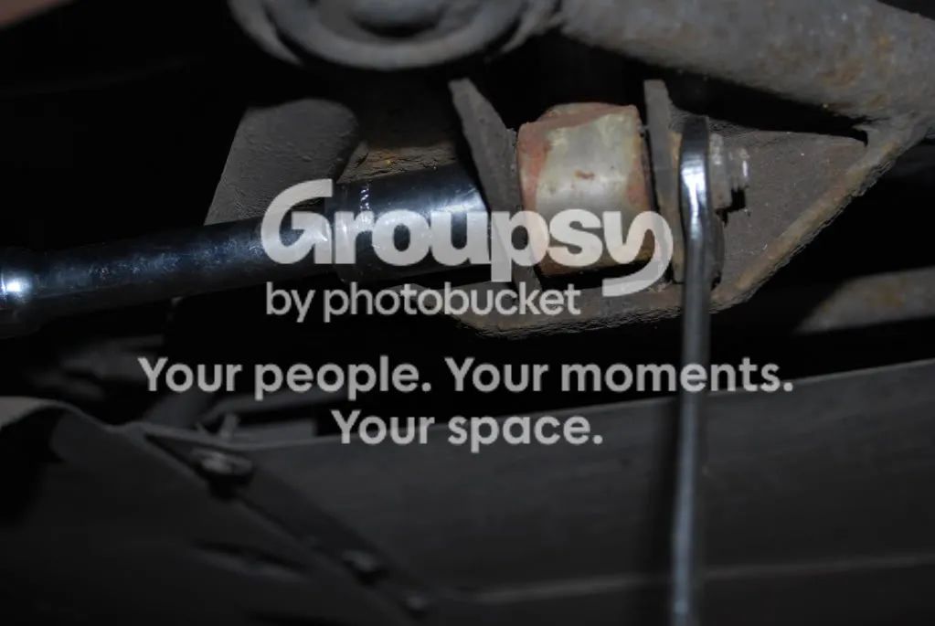 A spanner on the lower rear shock bolt on the underside of the lower wishbone