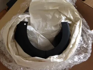 A new black lower steering column cowl in its wrapping