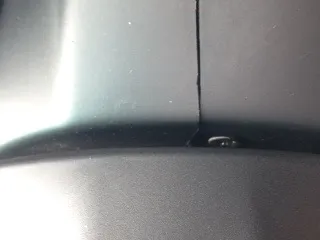 Close-up of a small screw in the join between the upper and lower column cowls