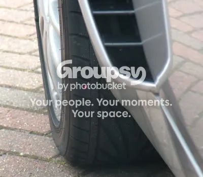 A close-up of the front tyre with the laser dot on the sidewall