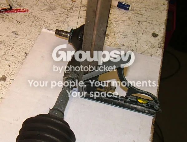 A steel square held against the track-rod end on a sheet of cardboard